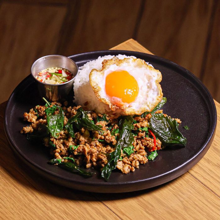 Thai basil chicken kaprao with fried egg over rice at BrewDog Bangkok
