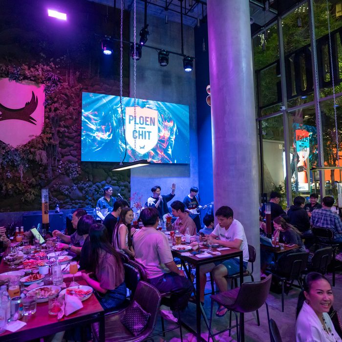 A crowd watching the big screen at BrewDog Bangkok